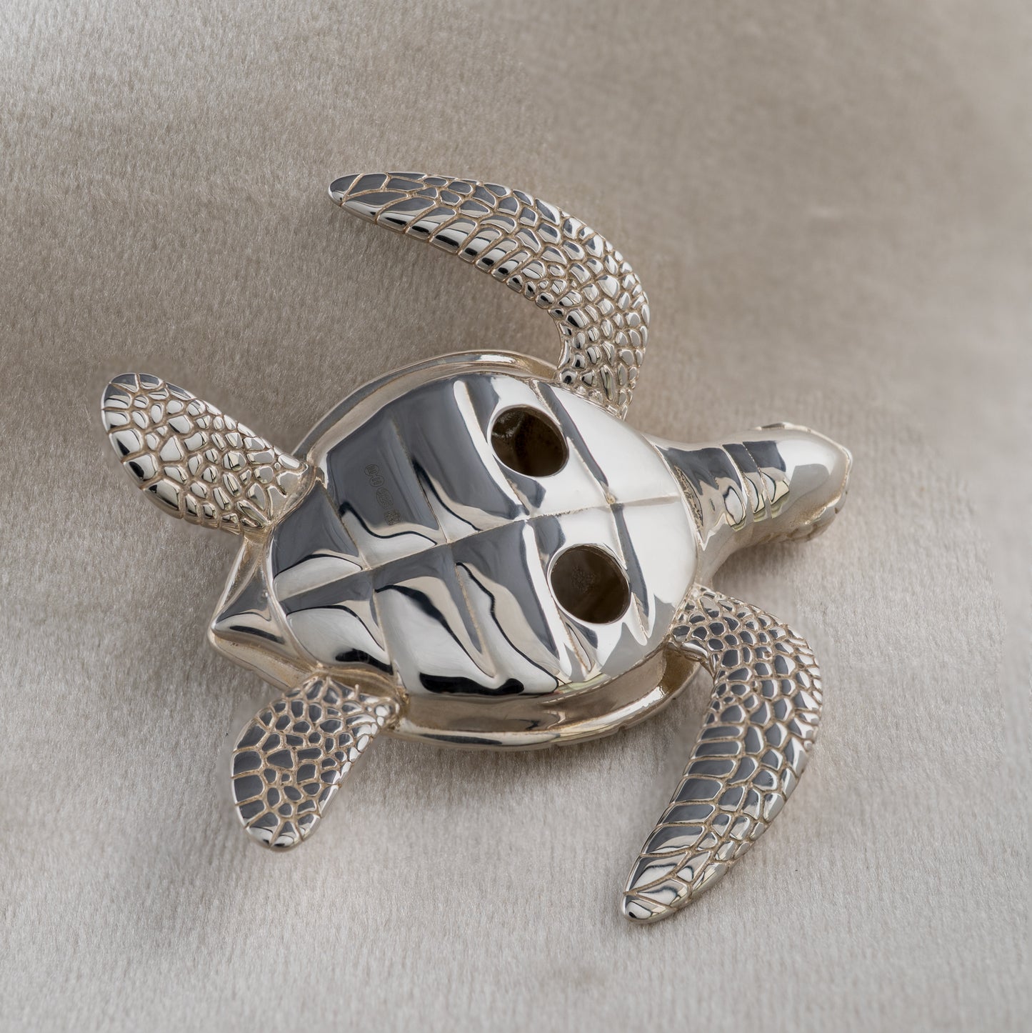 Underside of sterling silver sea turtle figurine showing hallmarked detail