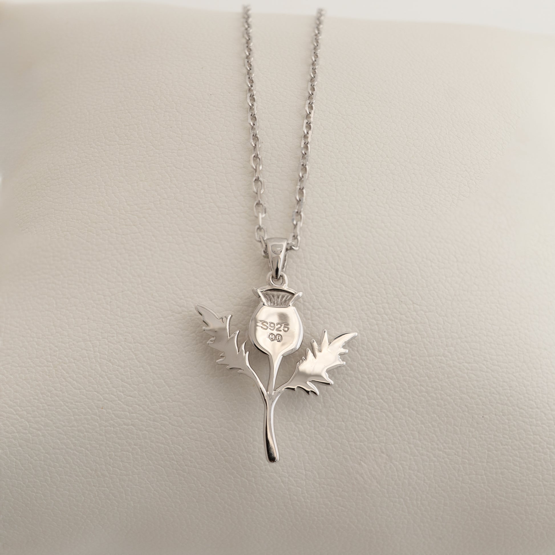 Sterling silver thistle necklace shown from reverse side with hallmarks