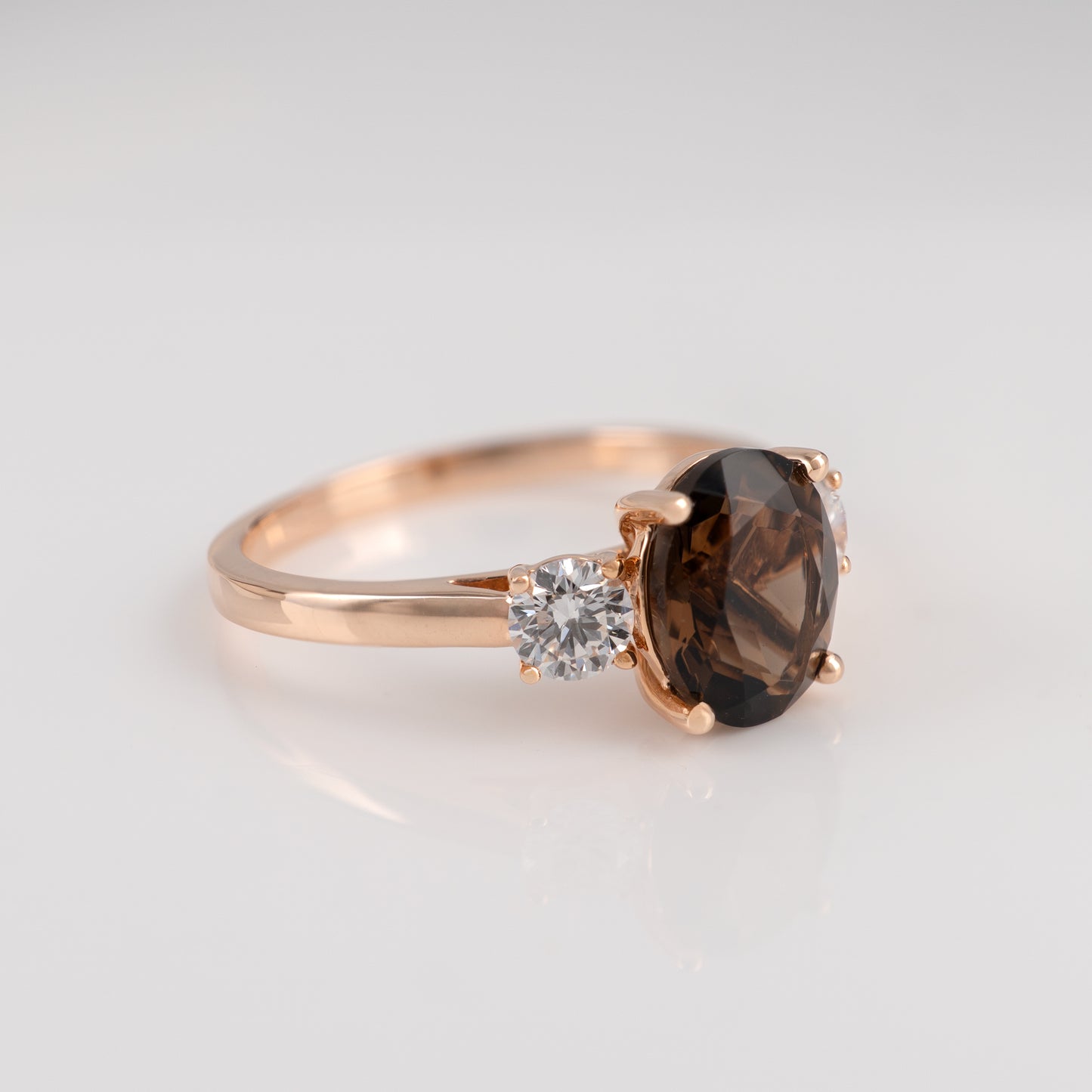 smoky quartz ring with a smoky gemstone and a smaller clear gemstone on a light gray background