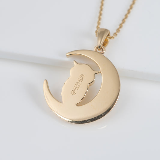 Reverse of gold owl pendant showing hallmark and maker's mark