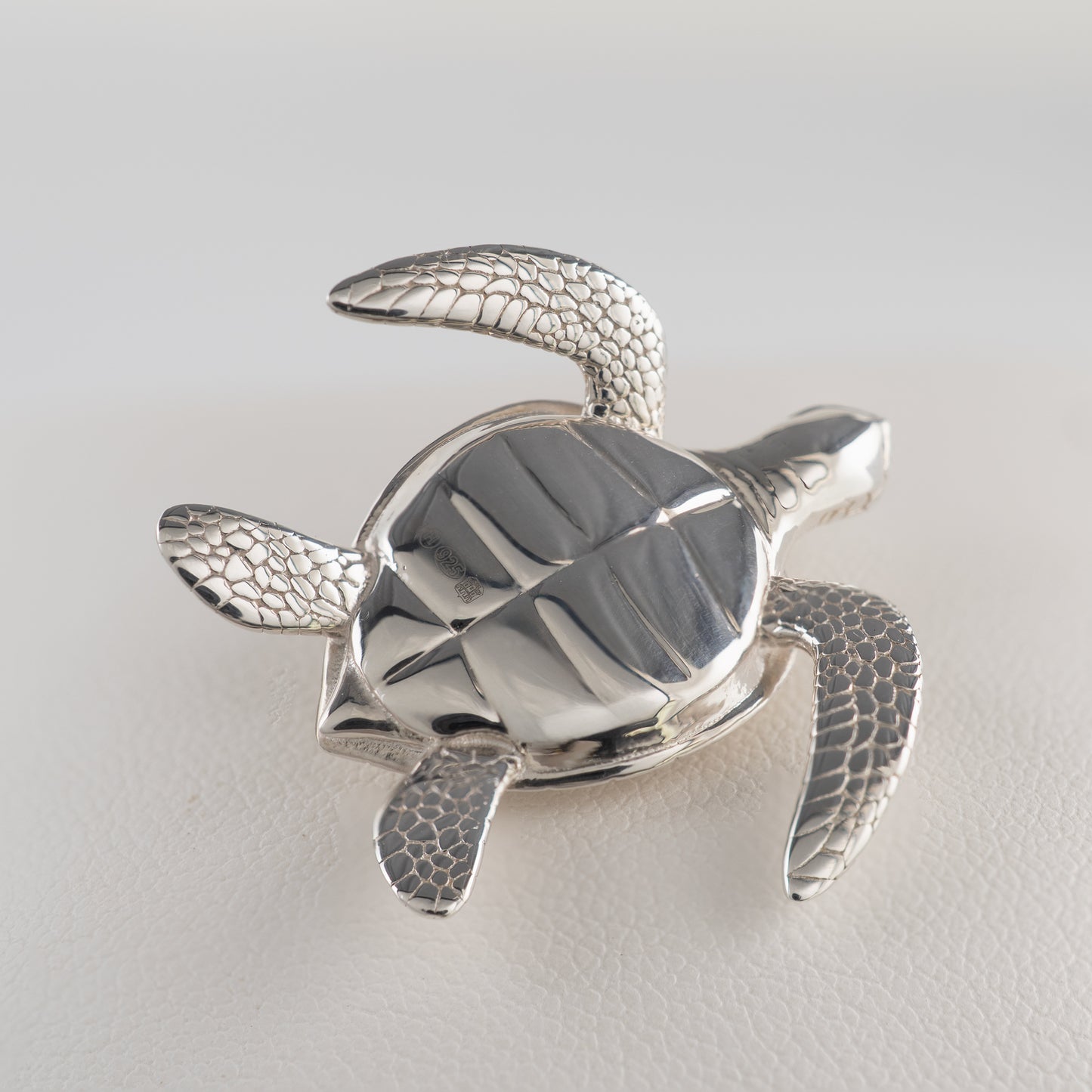 Underside of sterling silver sea turtle figurine showing assay hallmarked detail
