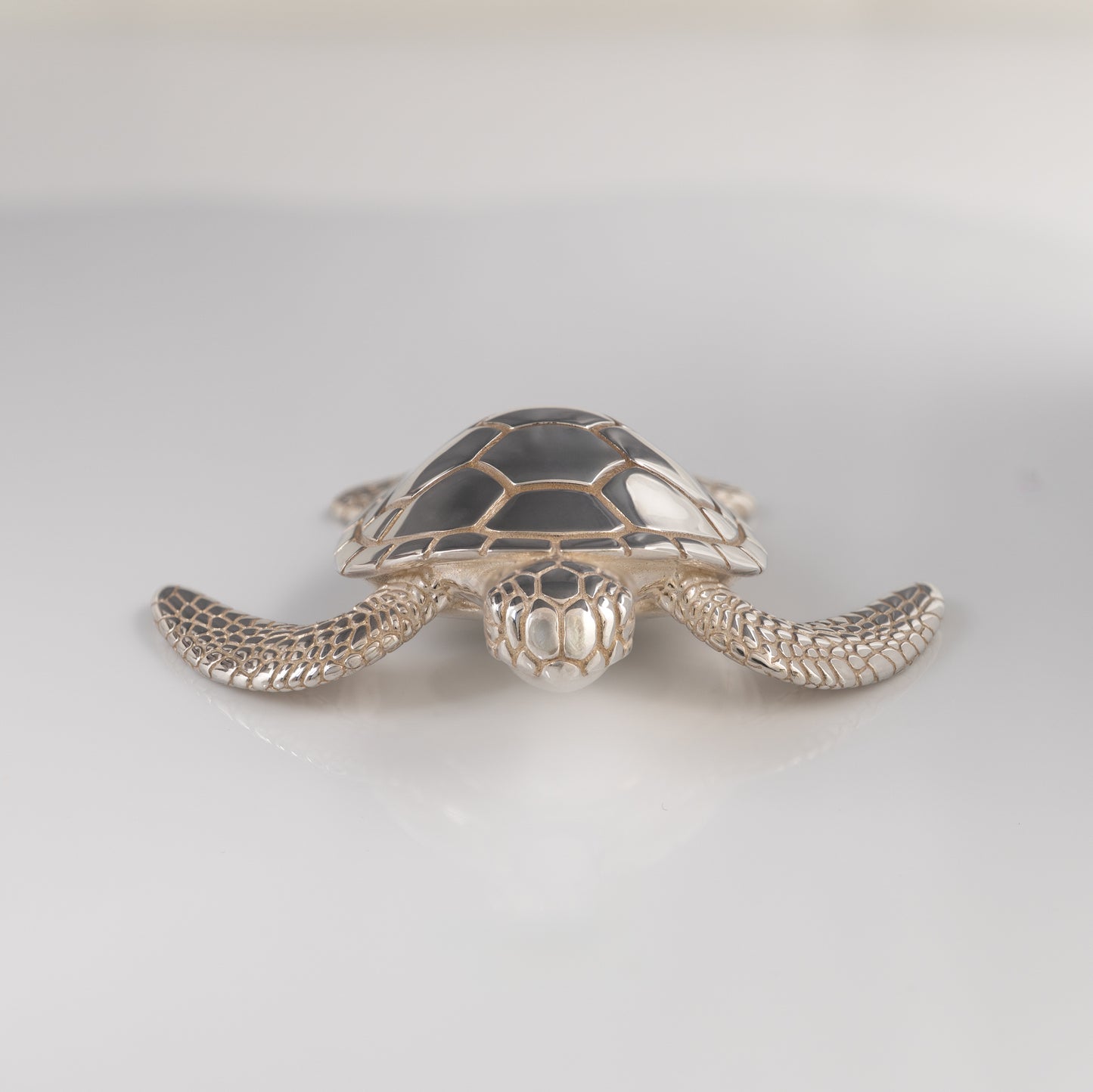 Sterling silver sea turtle figurine front view on white background