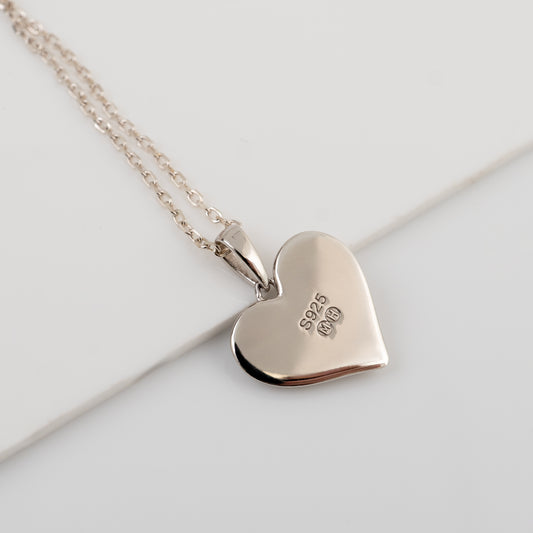 Reverse of sterling silver ruby heart necklace showing 925 and Michael Hunter makerβs marks