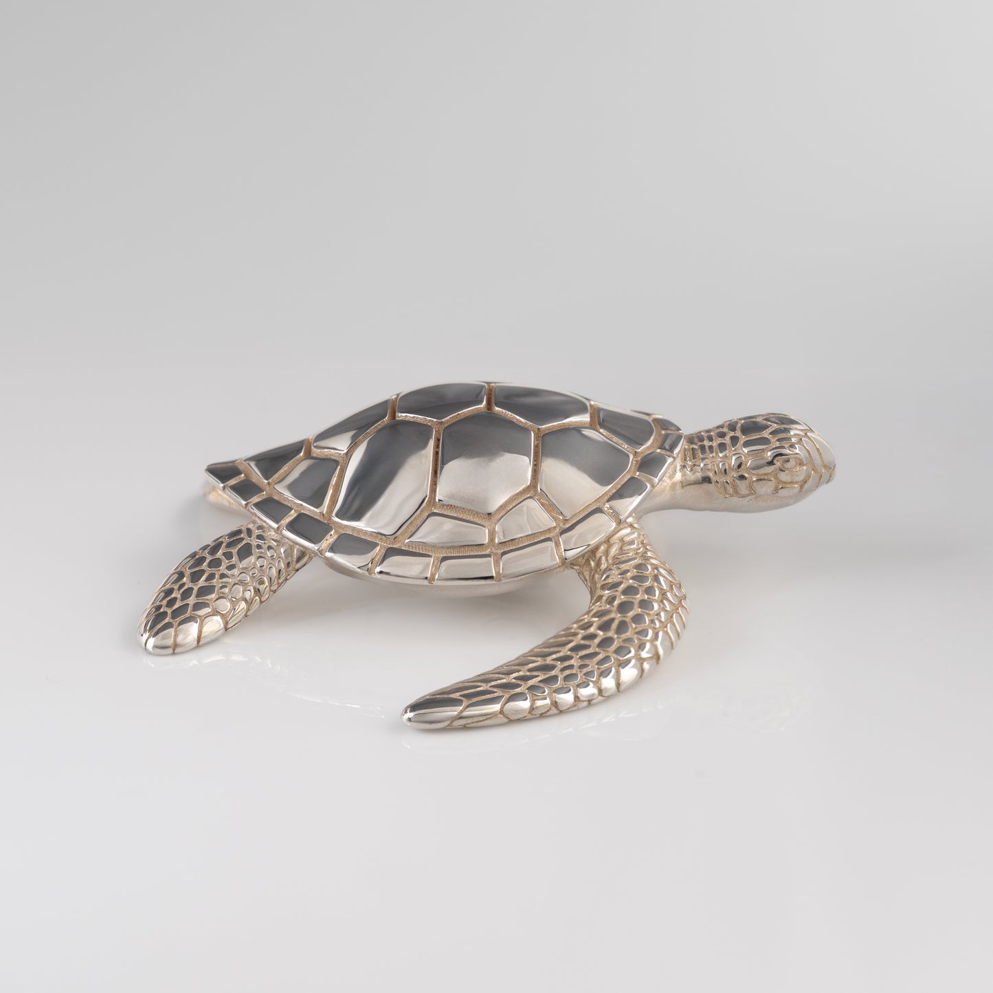 Sterling silver sea turtle figurine side view on white background