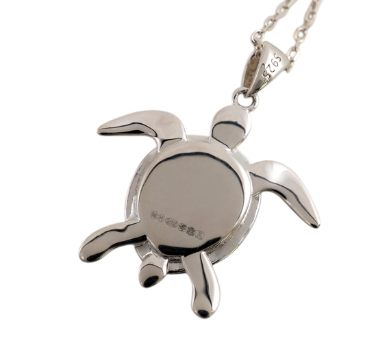 Smooth polished reverse of a sterling silver sea turtle pendant, showing hallmarks and a 925 mark on the bail
