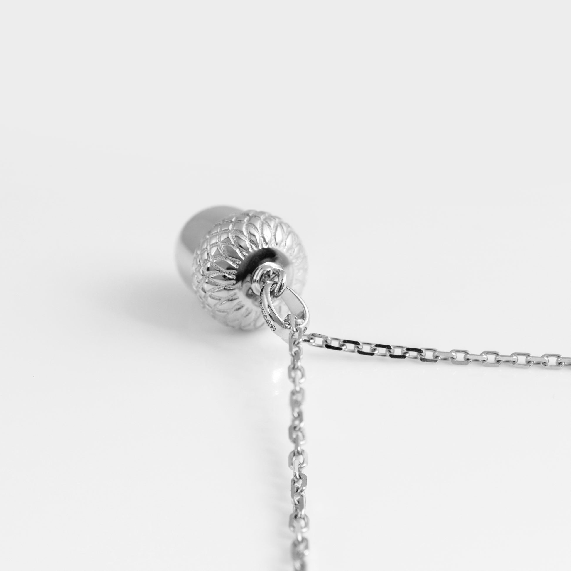 top-view-silver-acorn-pendant showing bail and chain
