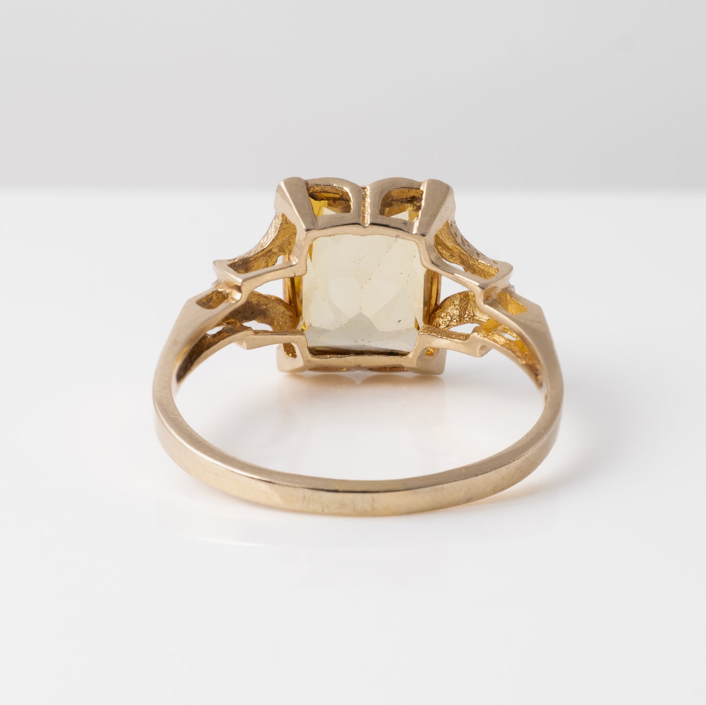 Back of the vintage citrine ring setting, highlighting the open goldwork design and pale citrine gemstone
