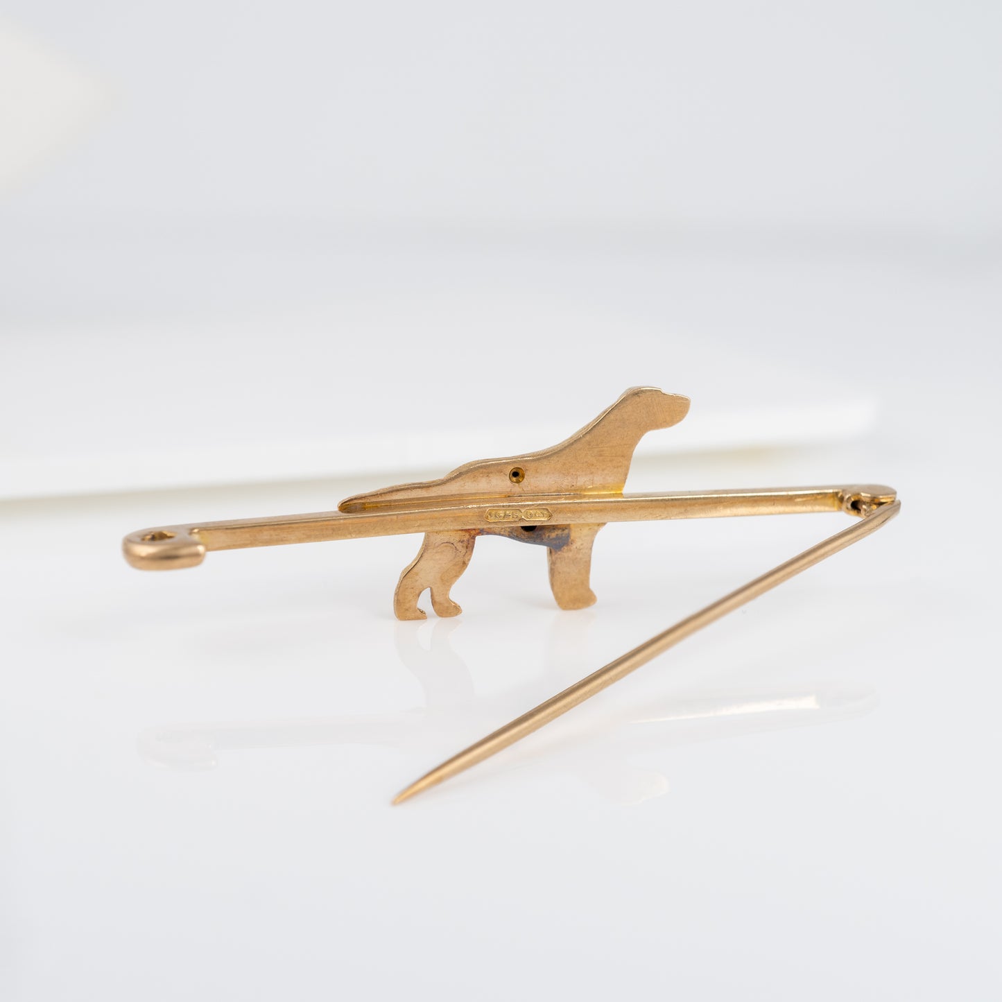 Reverse view of the vintage 9ct gold dog brooch showing the pin and hallmark