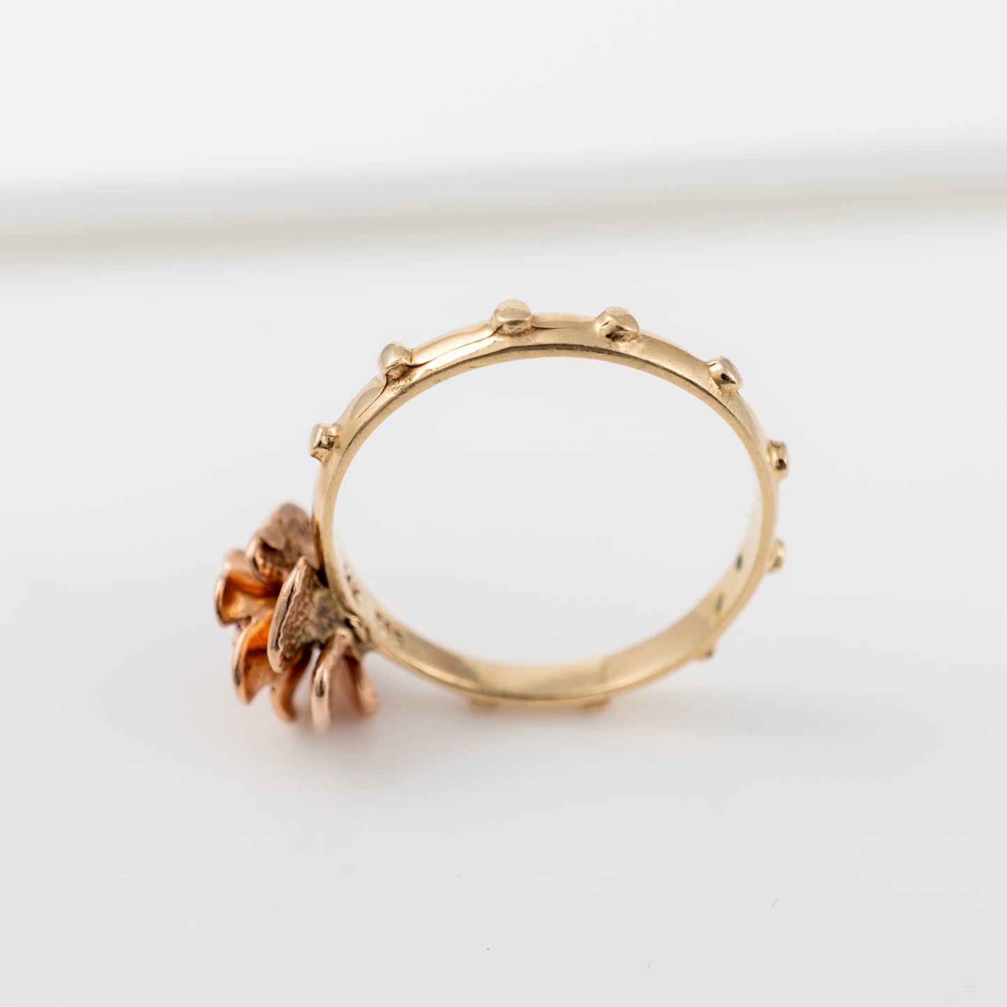 Side view of vintage 14K gold rosary ring showing nodules on the yellow gold band