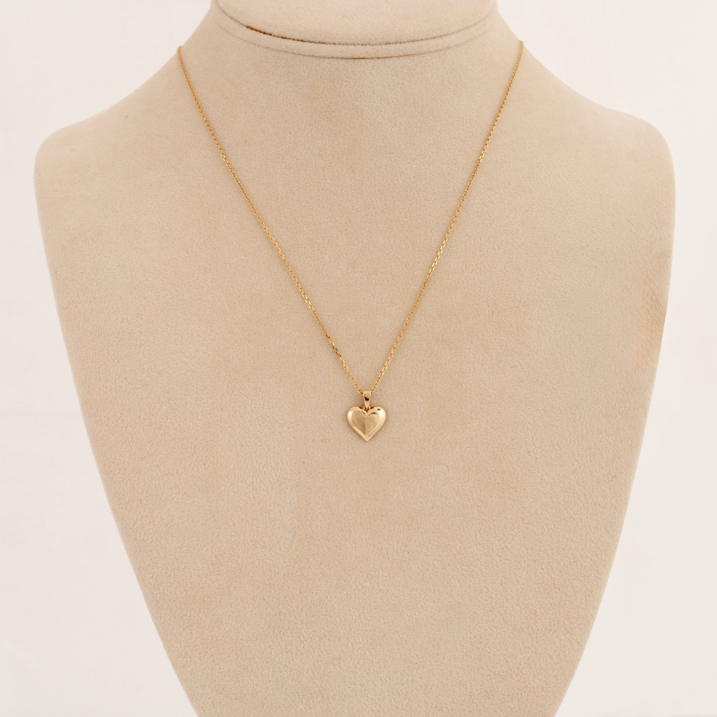 9ct gold heart necklace shown on display bust