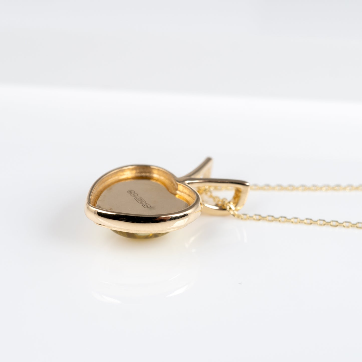 yellow gold heart necklace side view showing hallmarks