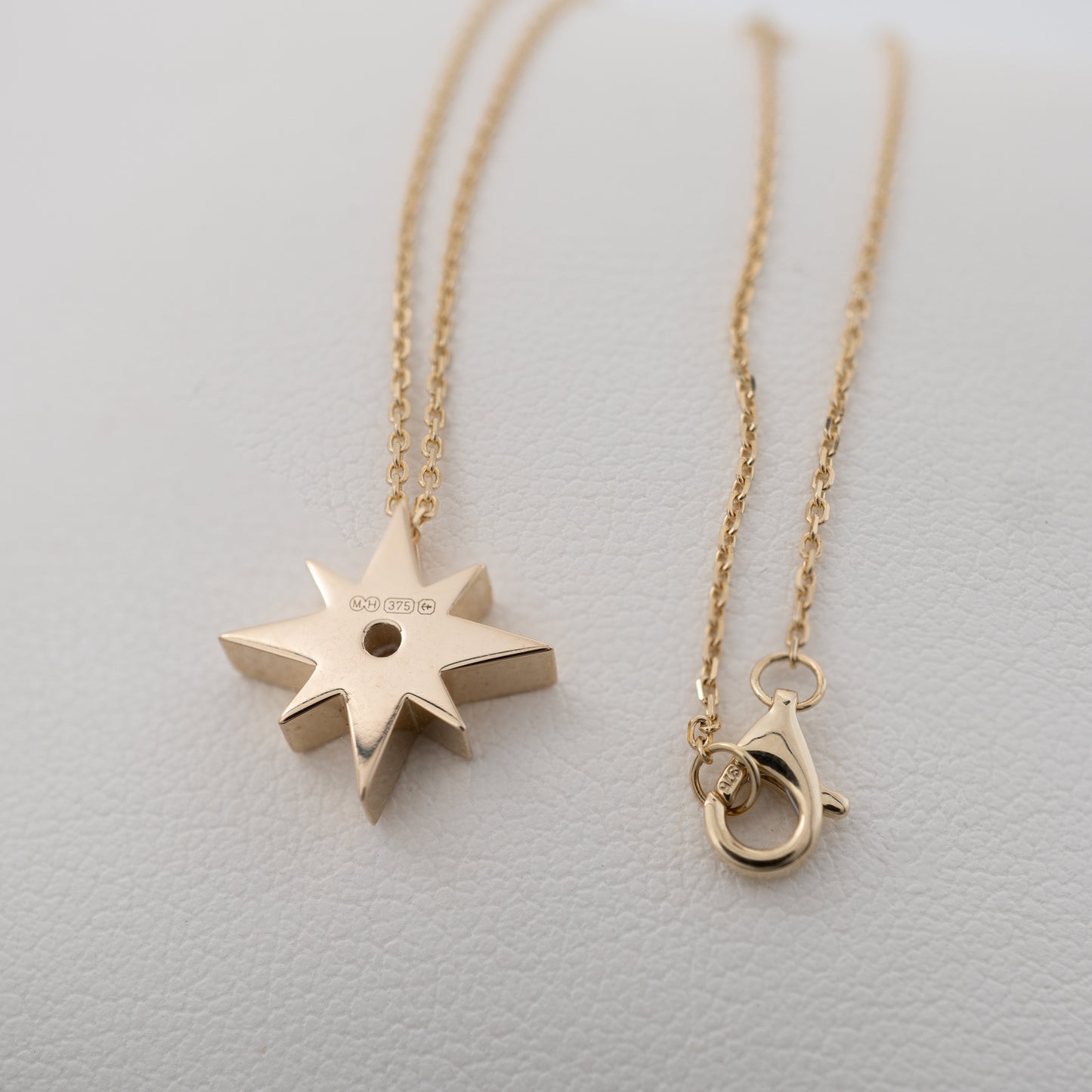 Back view of gold north star necklace showing full hallmarks and clasp – Hunters Fine Jewellery