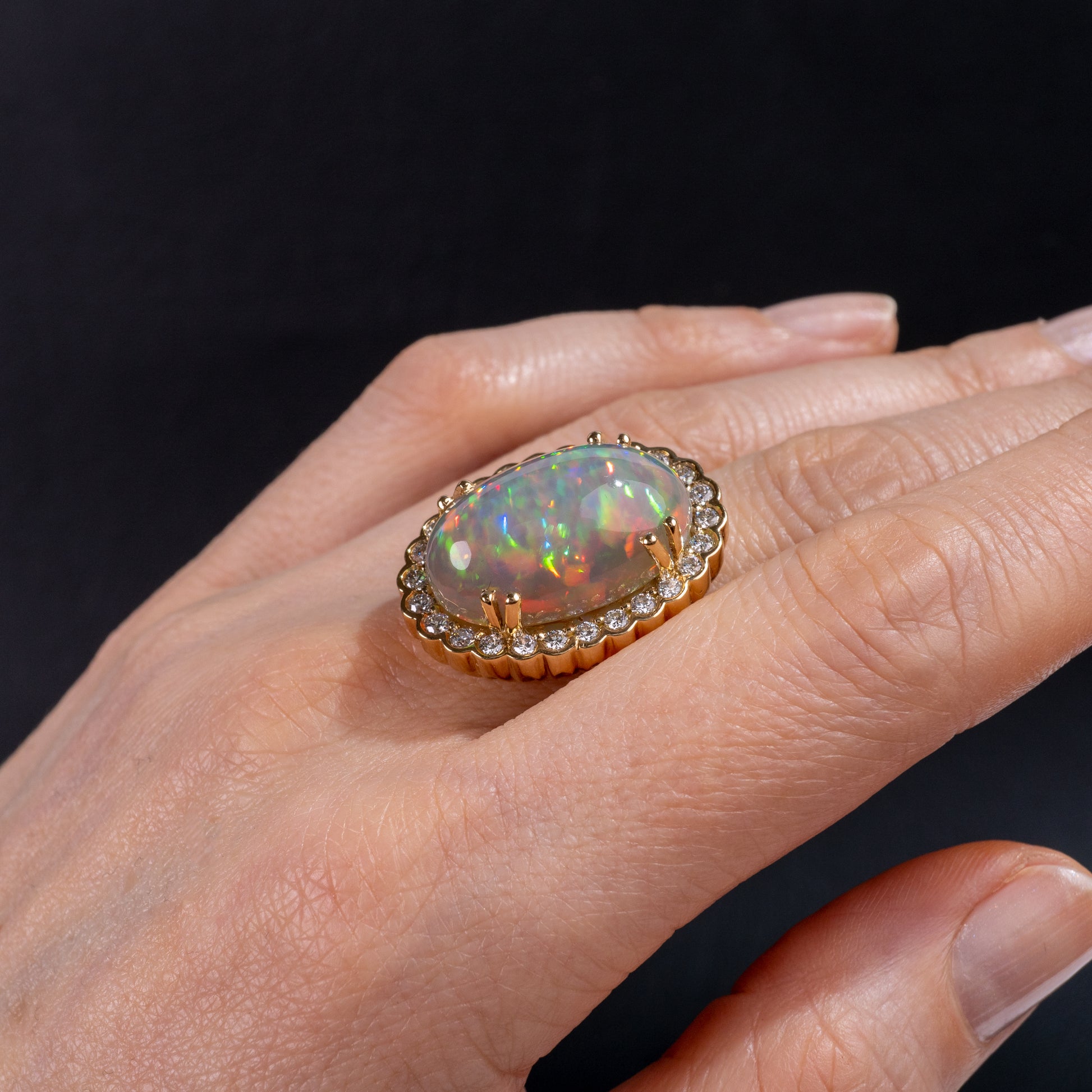large opal ring gold with diamond accents on hand