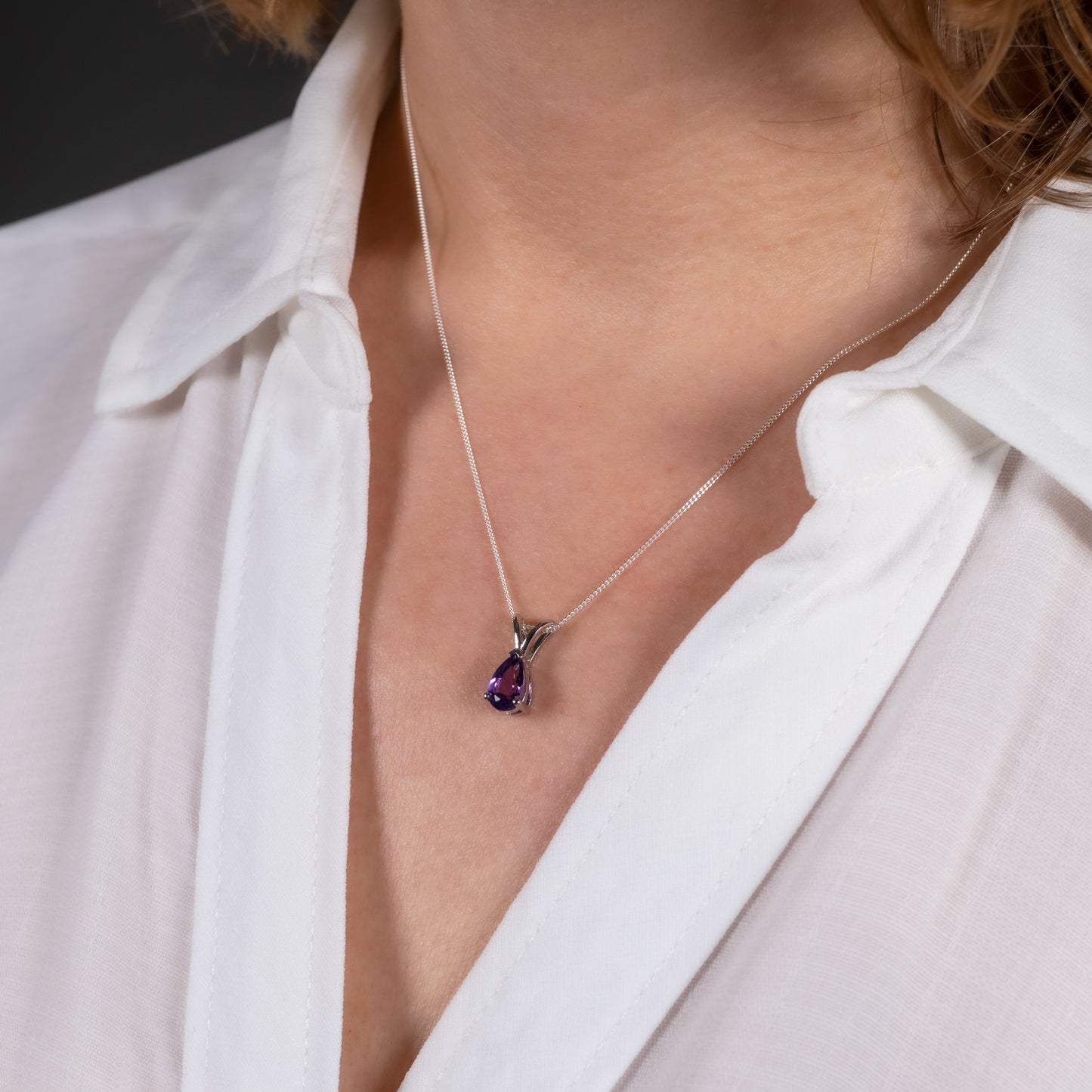 Amethyst teardrop pendant necklace worn on model with open shirt