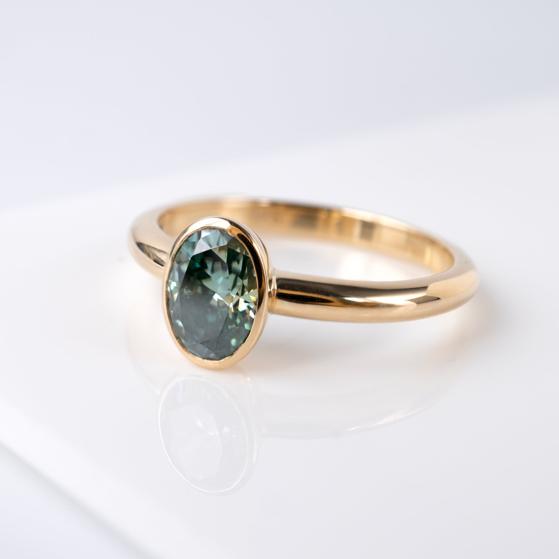teal green moissanite ring yellow gold