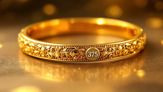 Close-up of an ornate 375 gold bangle with intricate detailing and a clearly visible 375 hallmark, set against a warm golden background.