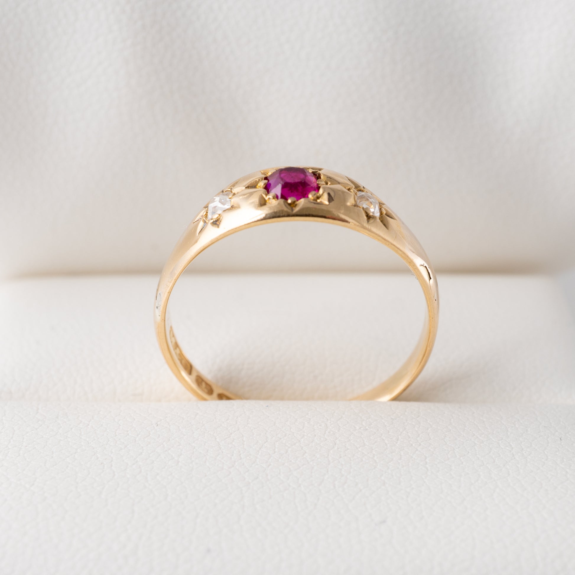 Antique 18ct gold gypsy ring with natural ruby and old cut diamonds in star settings, displayed on a jewellery box