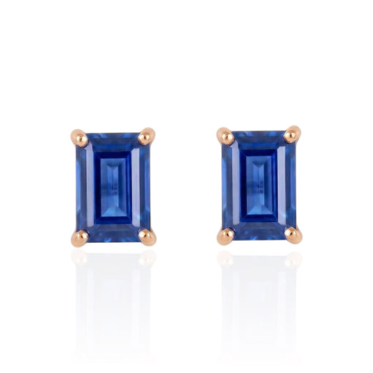 Pair of blue lab sapphire studs earrings earrings with rose gold settings on a white background
