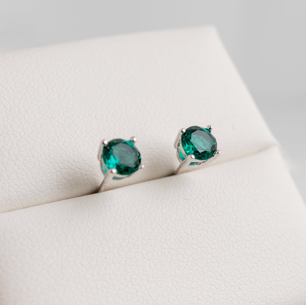 5mm round lab emerald stud earrings in sterling silver with deep green stones
