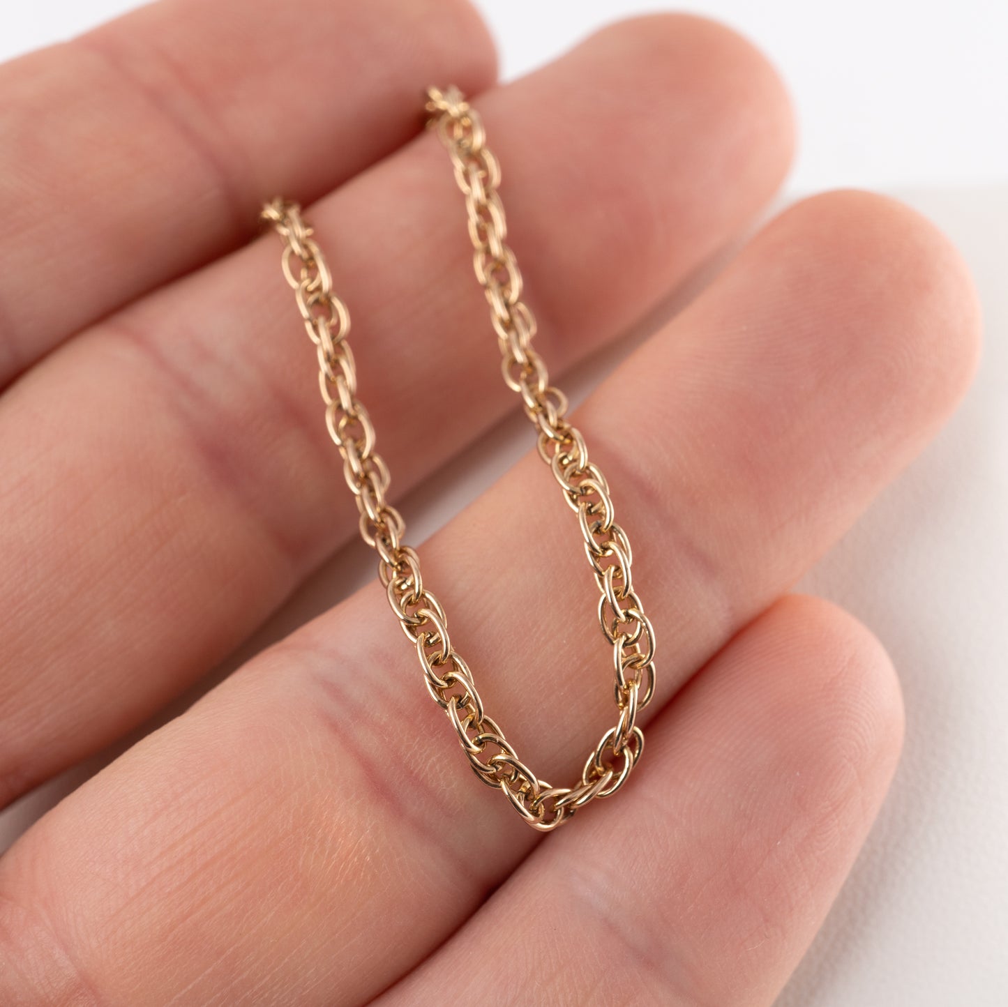 Close-up of a pre-owned 375 gold fancy link bracelet held in hand – Hunters Fine Jewellery