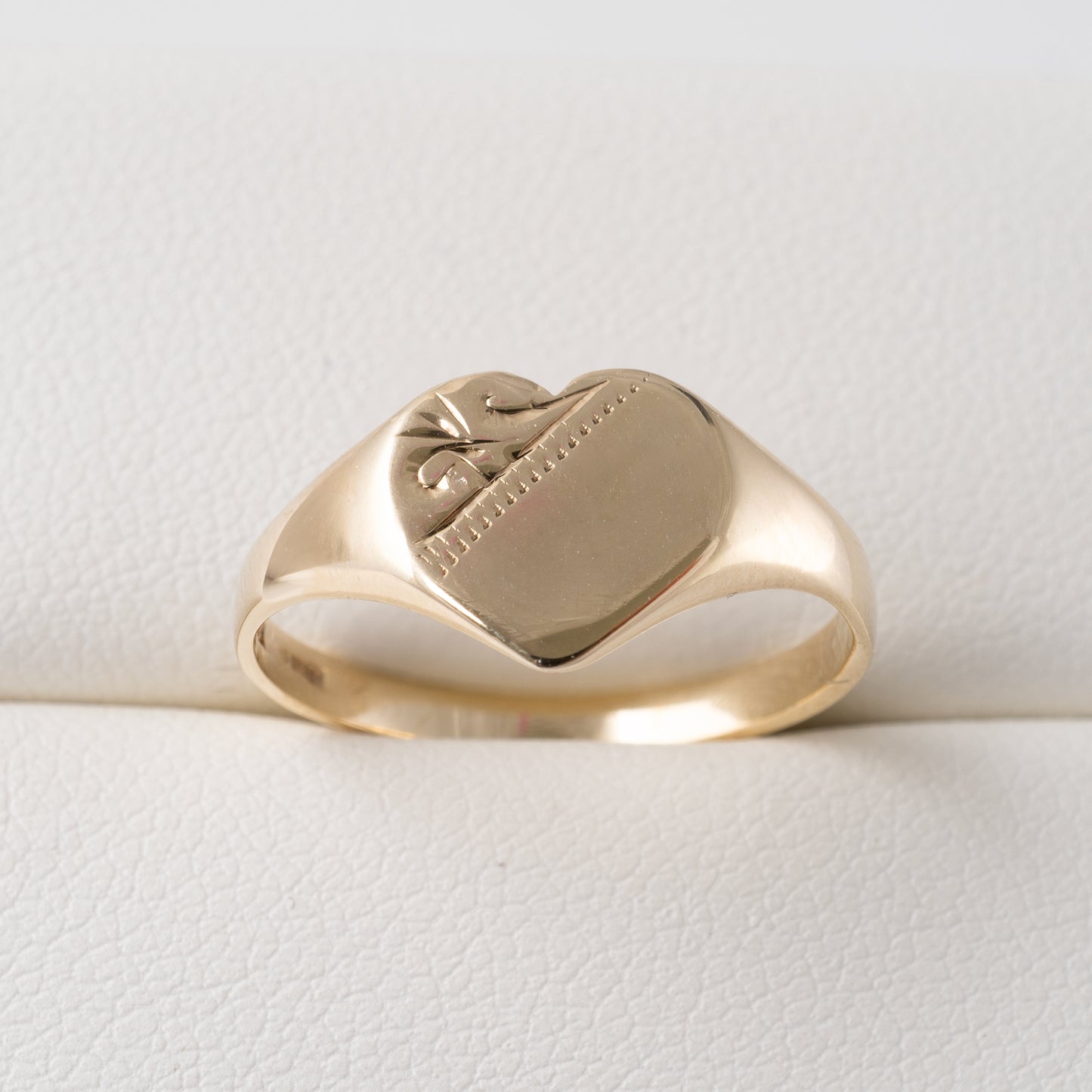 9ct gold heart signet ring – close-up of engraved detailing and polished finish.