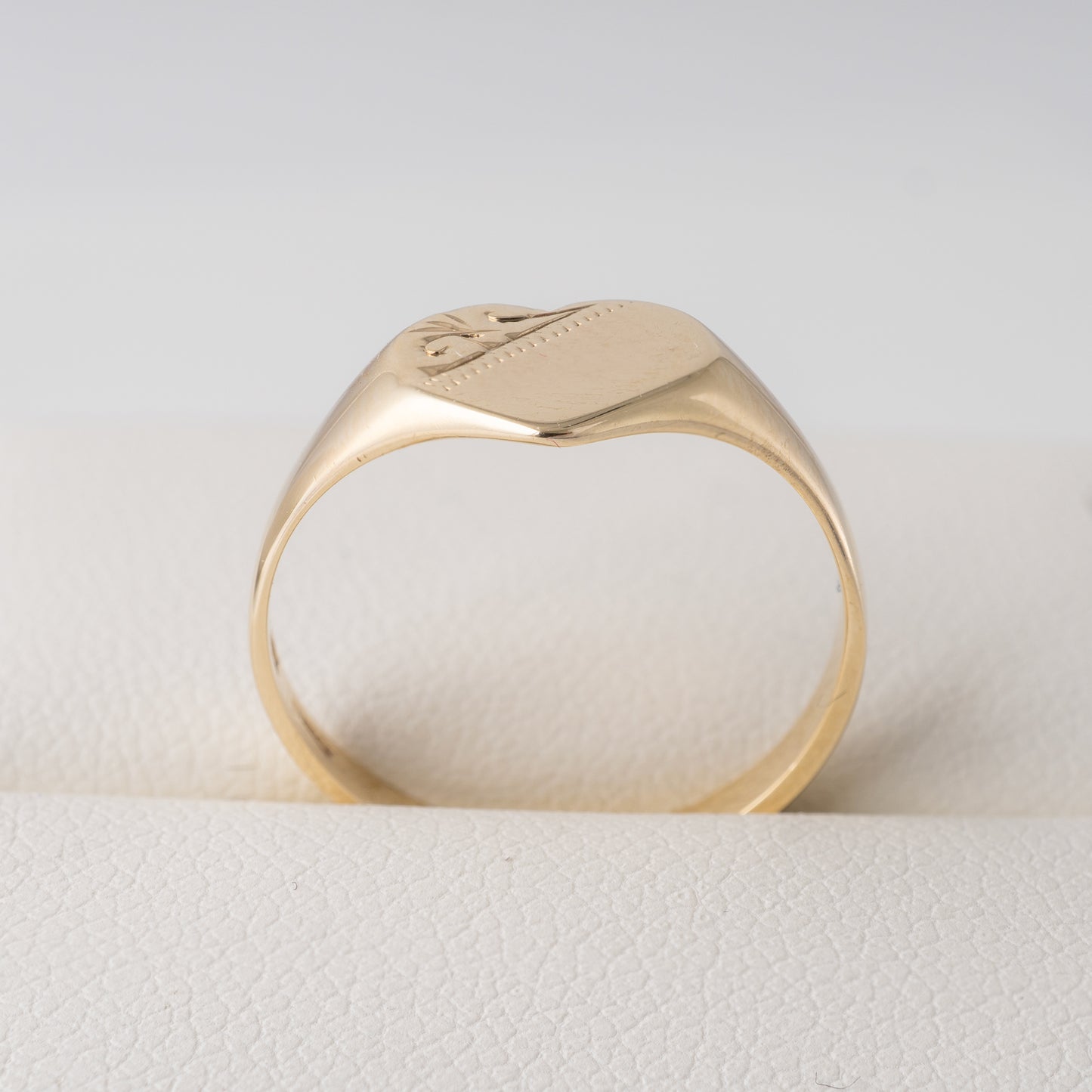 375 gold heart signet ring – side view showing tapered band and engraved details.