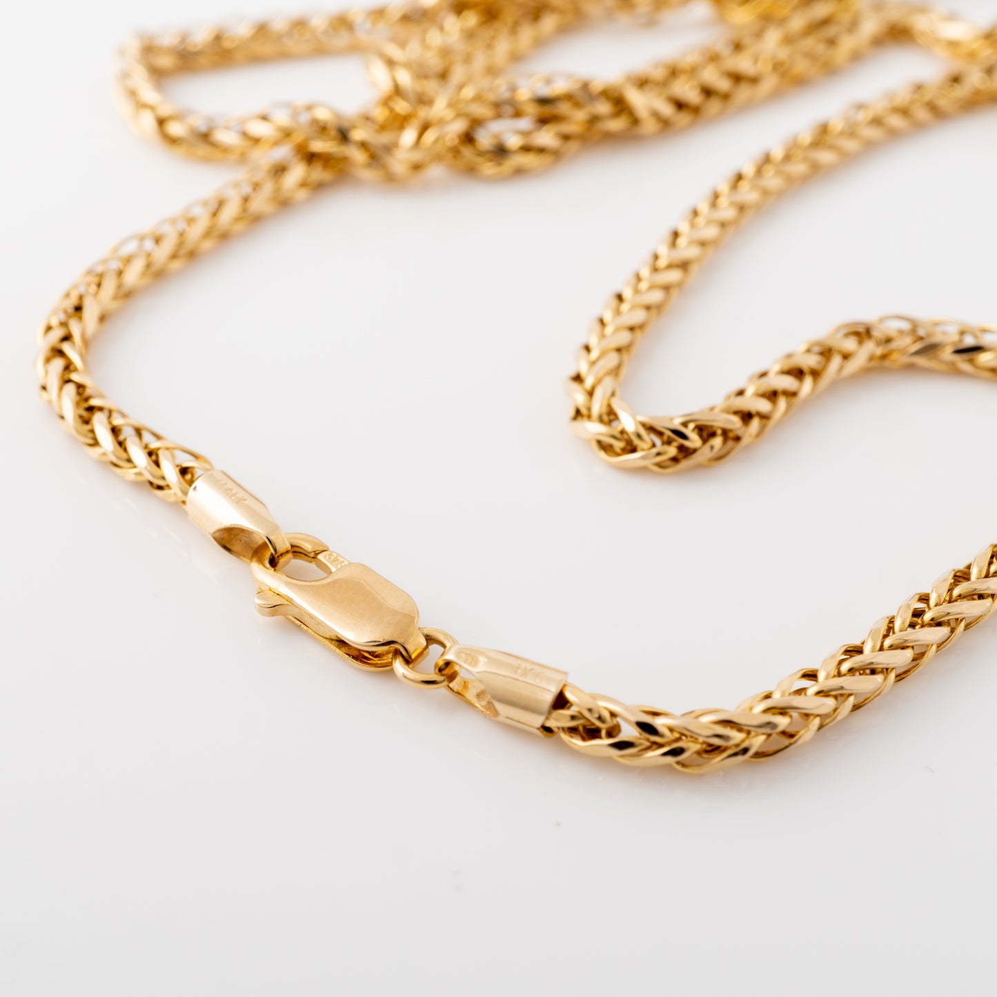 Detailed image of the 9ct gold spiga chain necklace with a secure lobster claw clasp