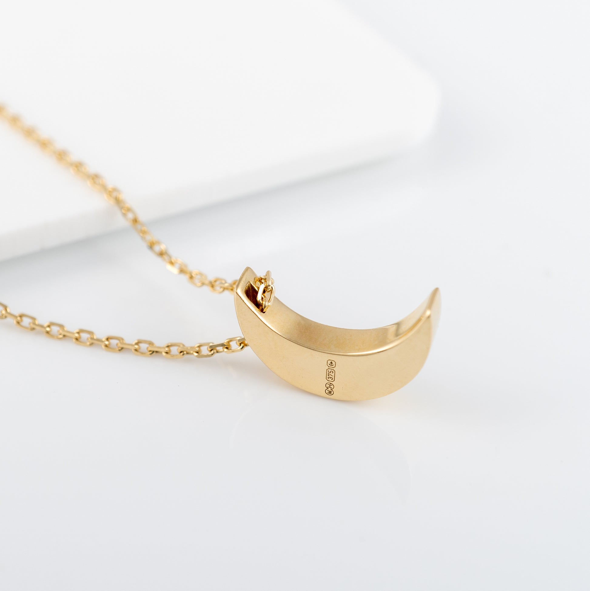 Side angle of gold crescent moon necklace with lab-grown diamonds