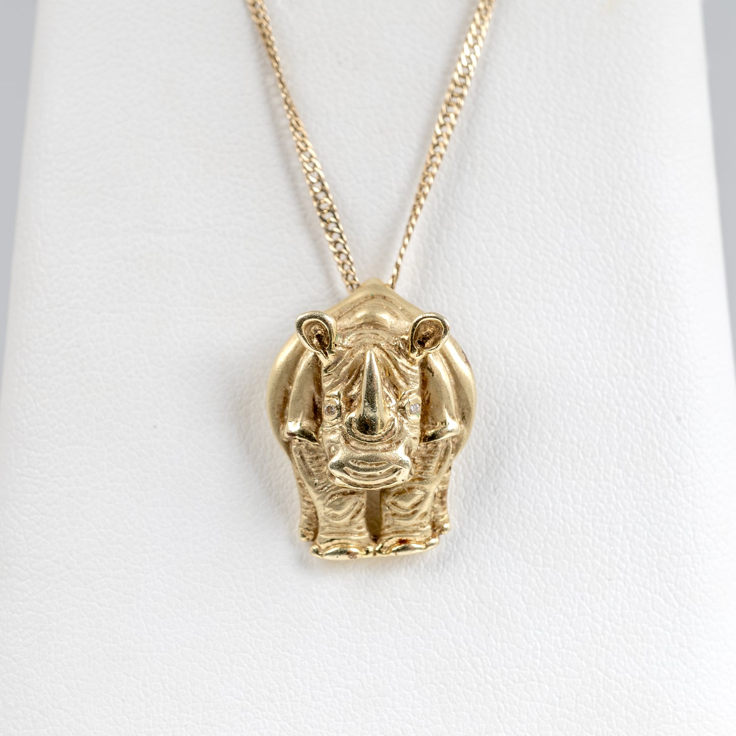 Close-up of rhinoceros pendant with diamond eyes