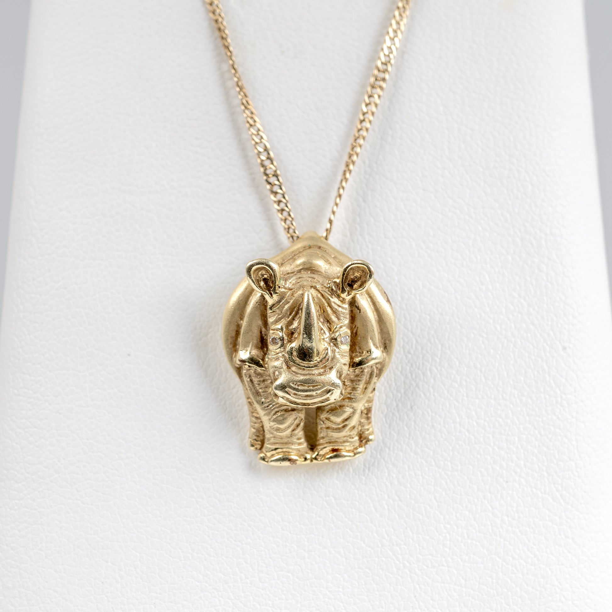 Close-up of rhinoceros pendant with diamond eyes