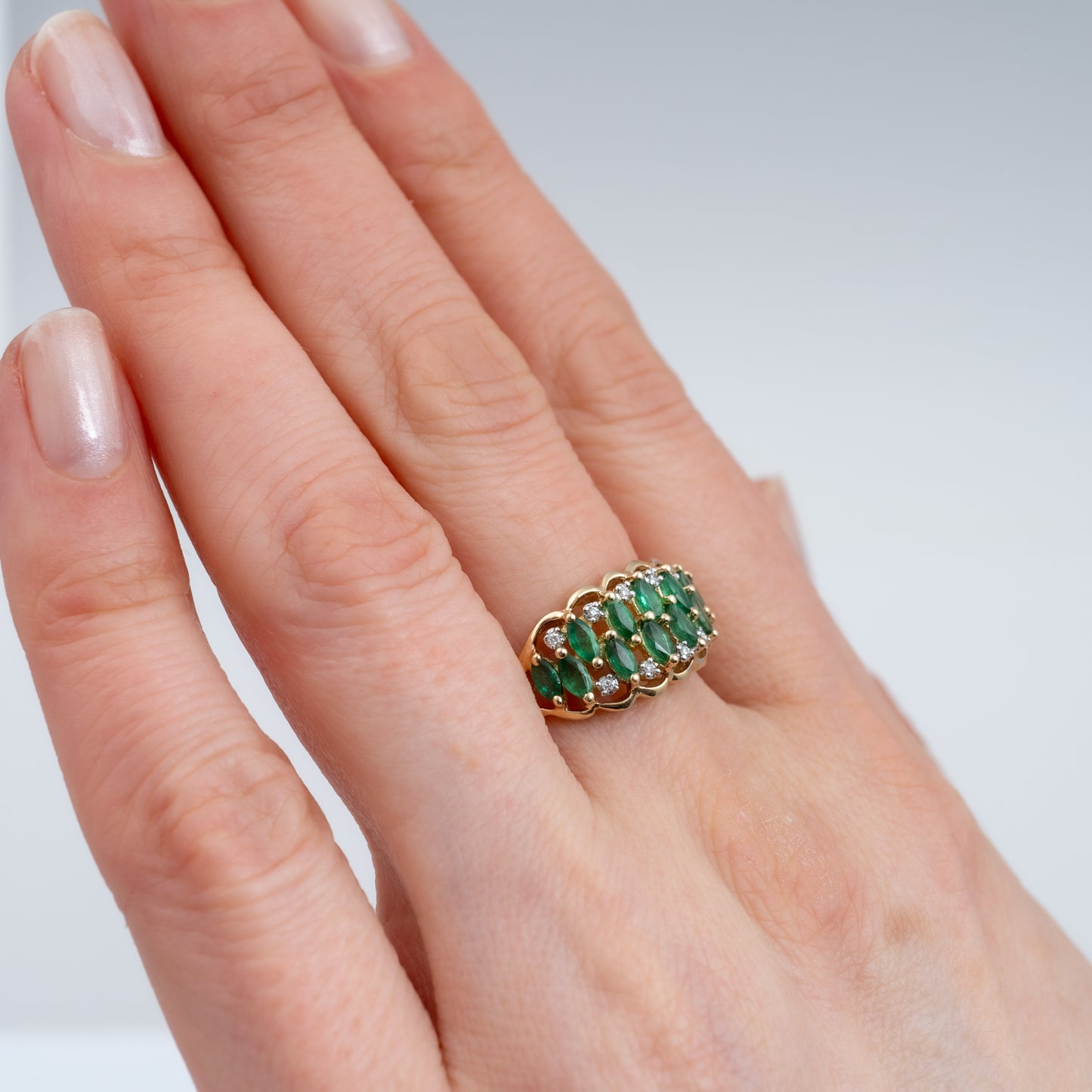 woman wearing emerald ring