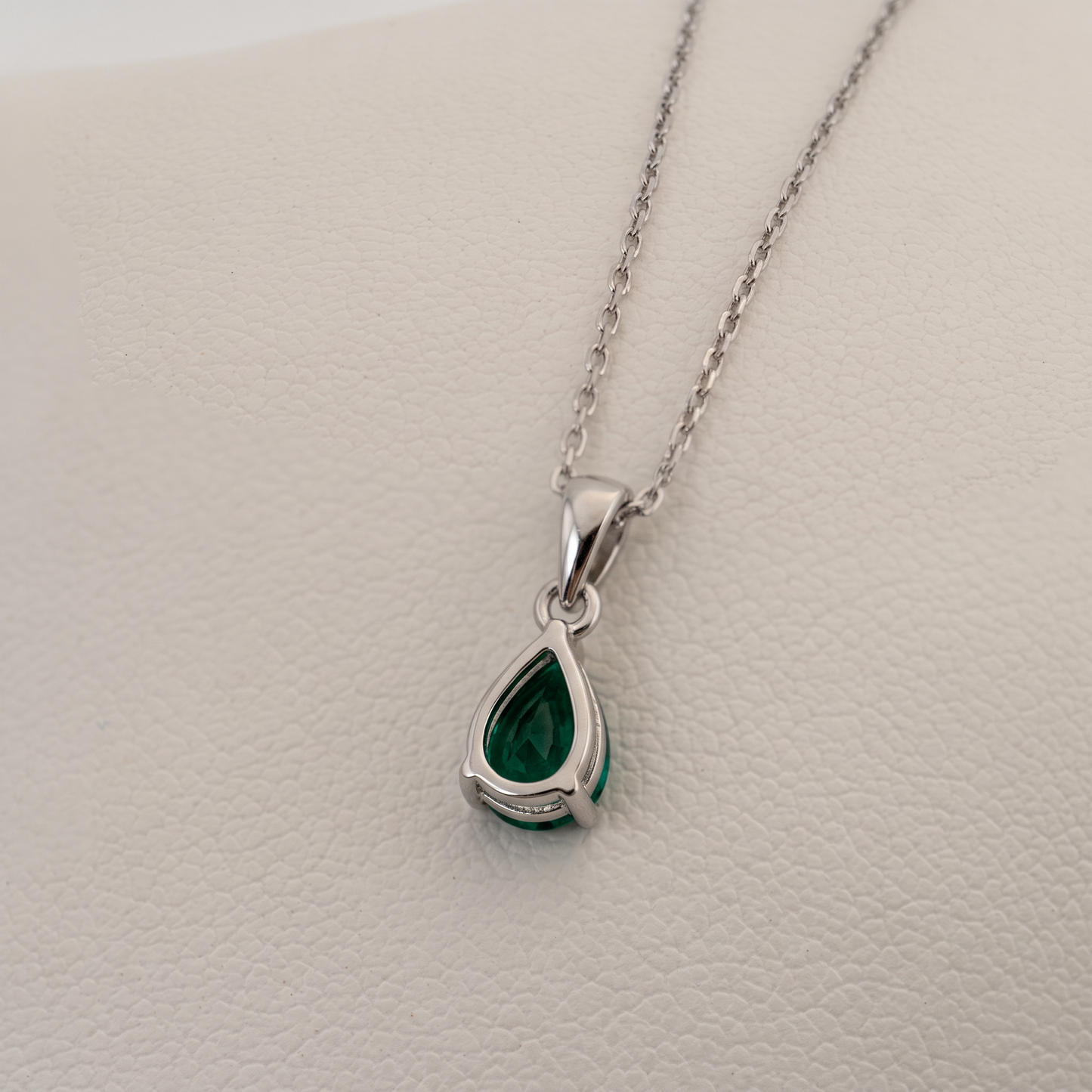 lab emerald pear pendant siilver setting reverse side showing back of stone 
