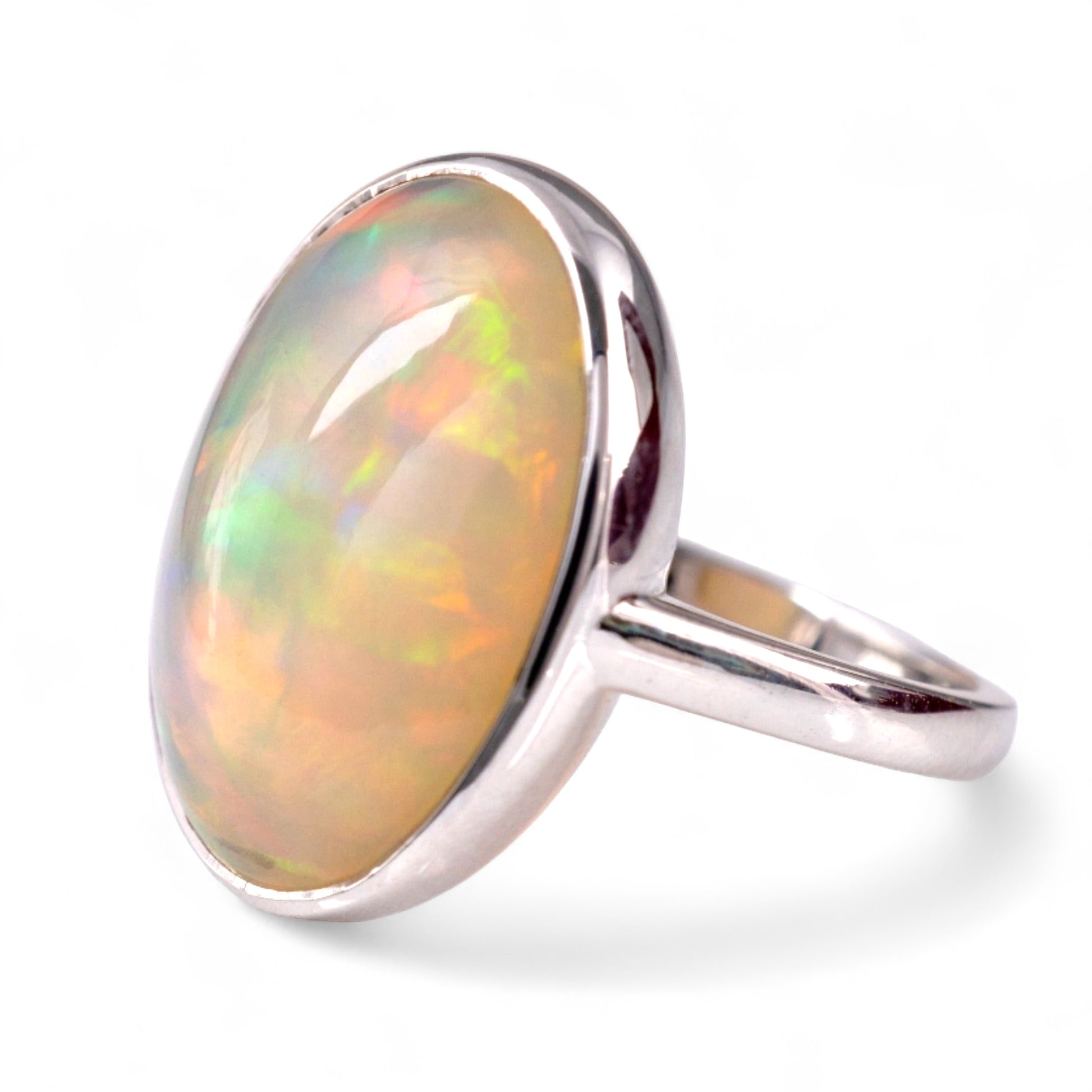 Opal solitaire ring white gold bezel setting 