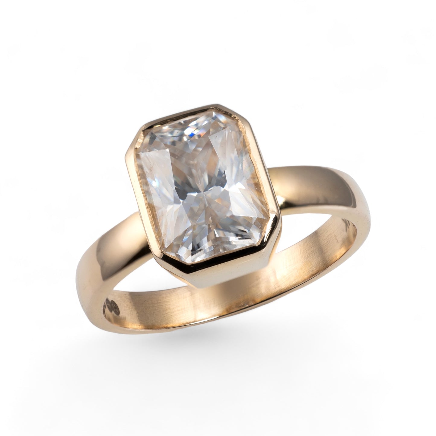 Moissanite ring emerald cut bezel setting yellow gold band 