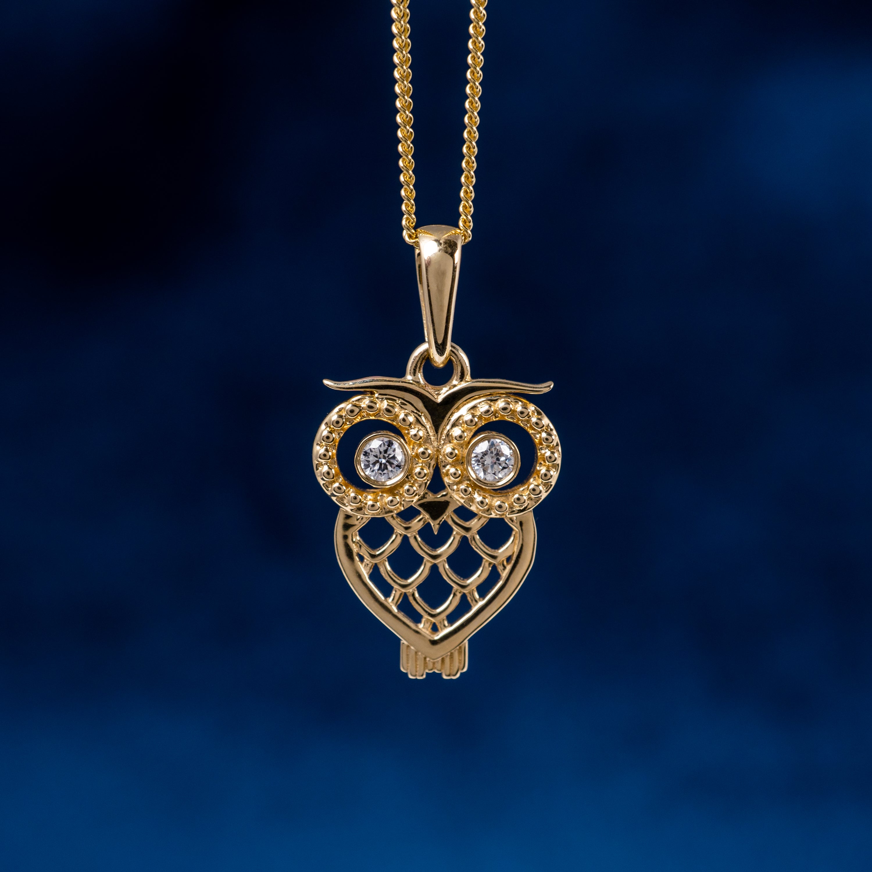 Gold owl pendant with diamond eyes 