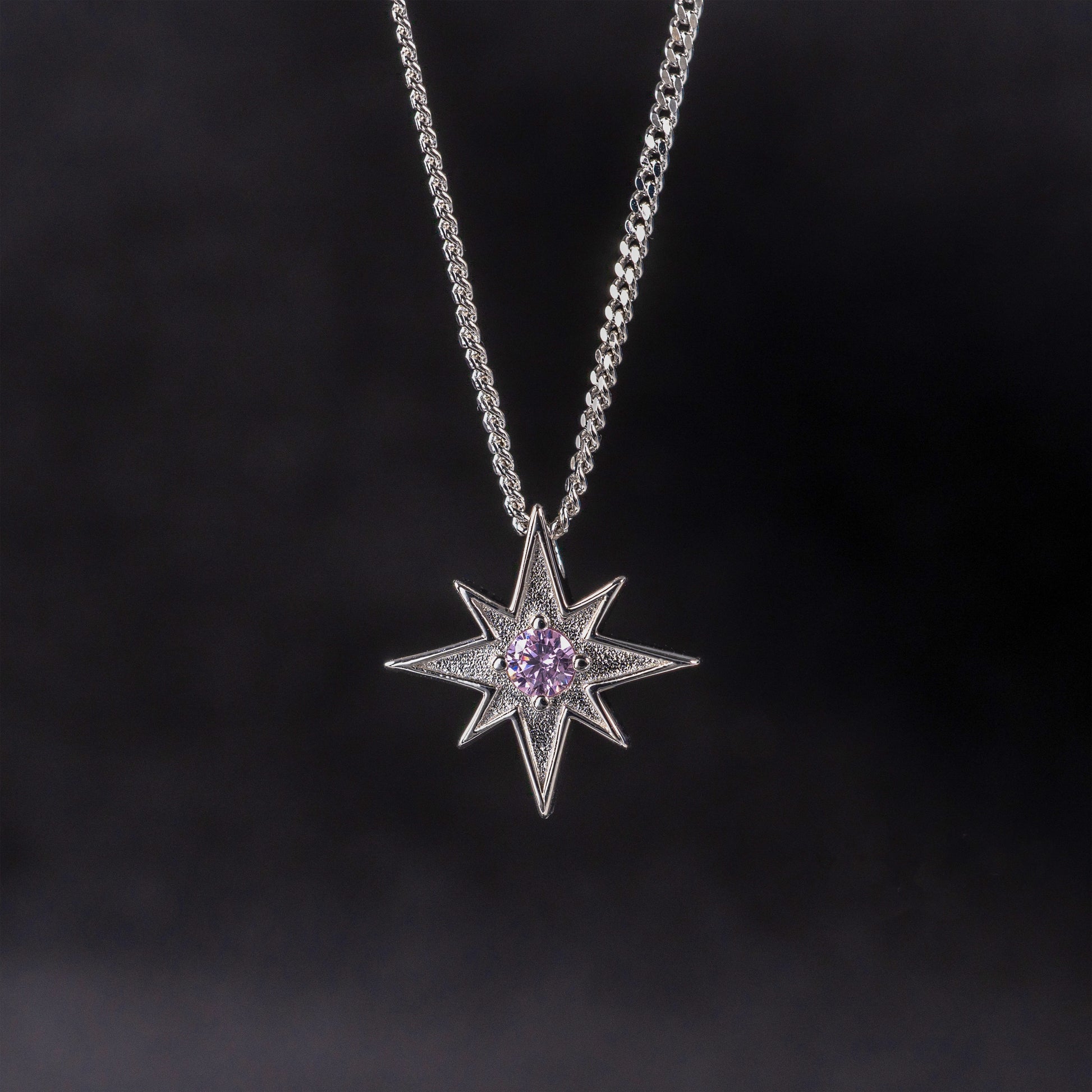 North Star necklace in silver with pink gemstone against dark background