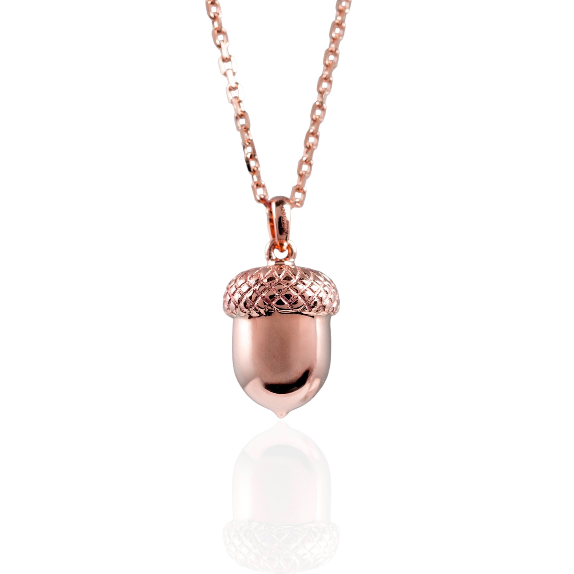 Rose gold acorn pendant necklace on a white background