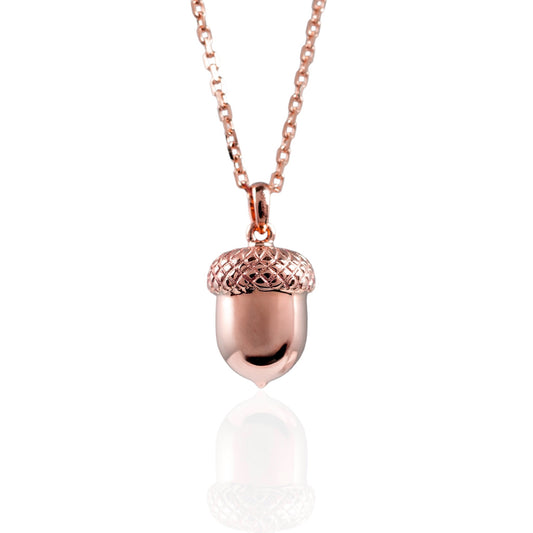Rose gold acorn pendant necklace on a white background