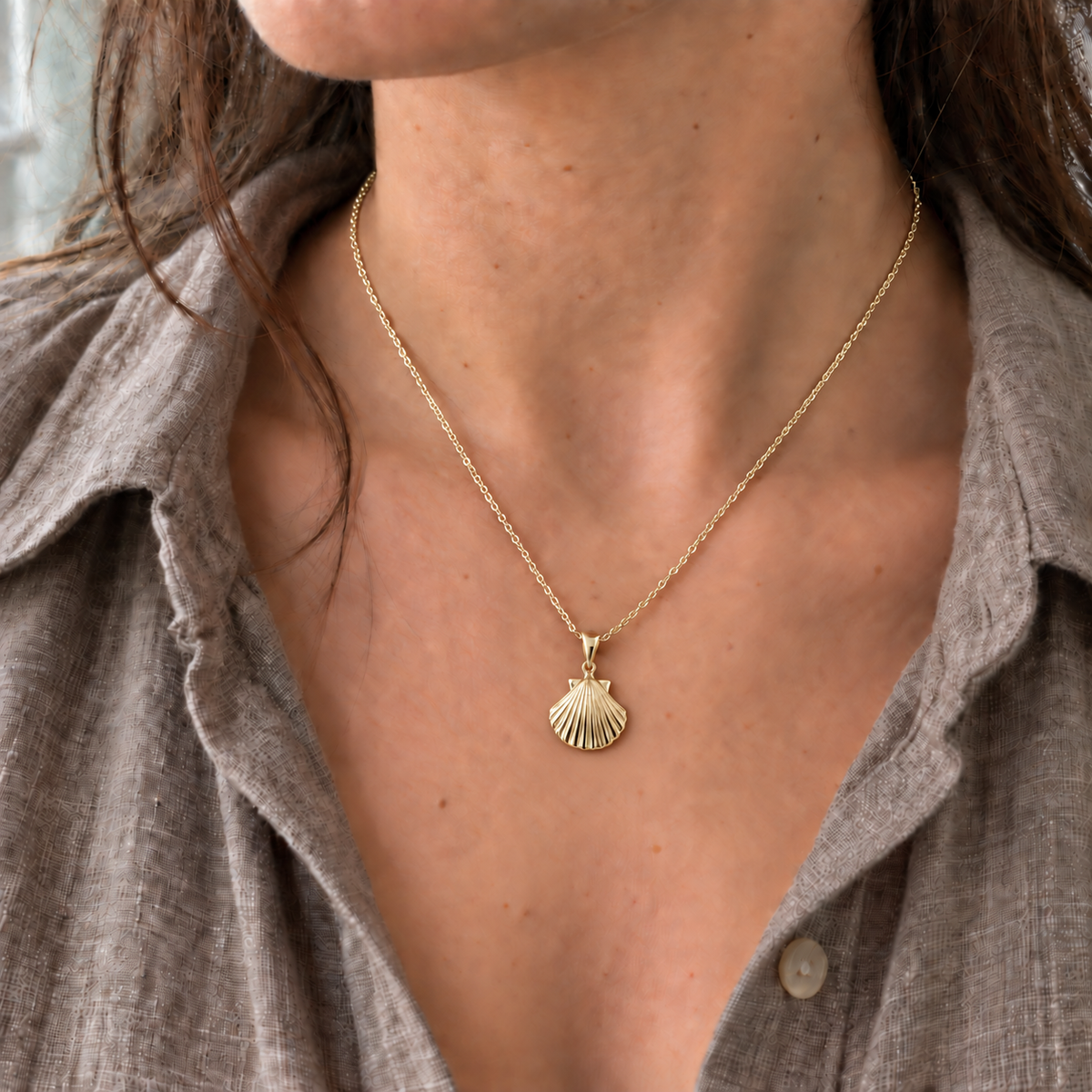 Model wearing a 9ct gold scallop shell necklace