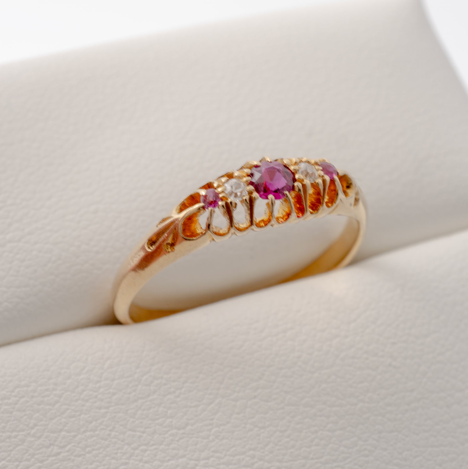 Side view of an antique ruby and diamond ring in 18ct gold, highlighting the intricate design and gemstone arrangement