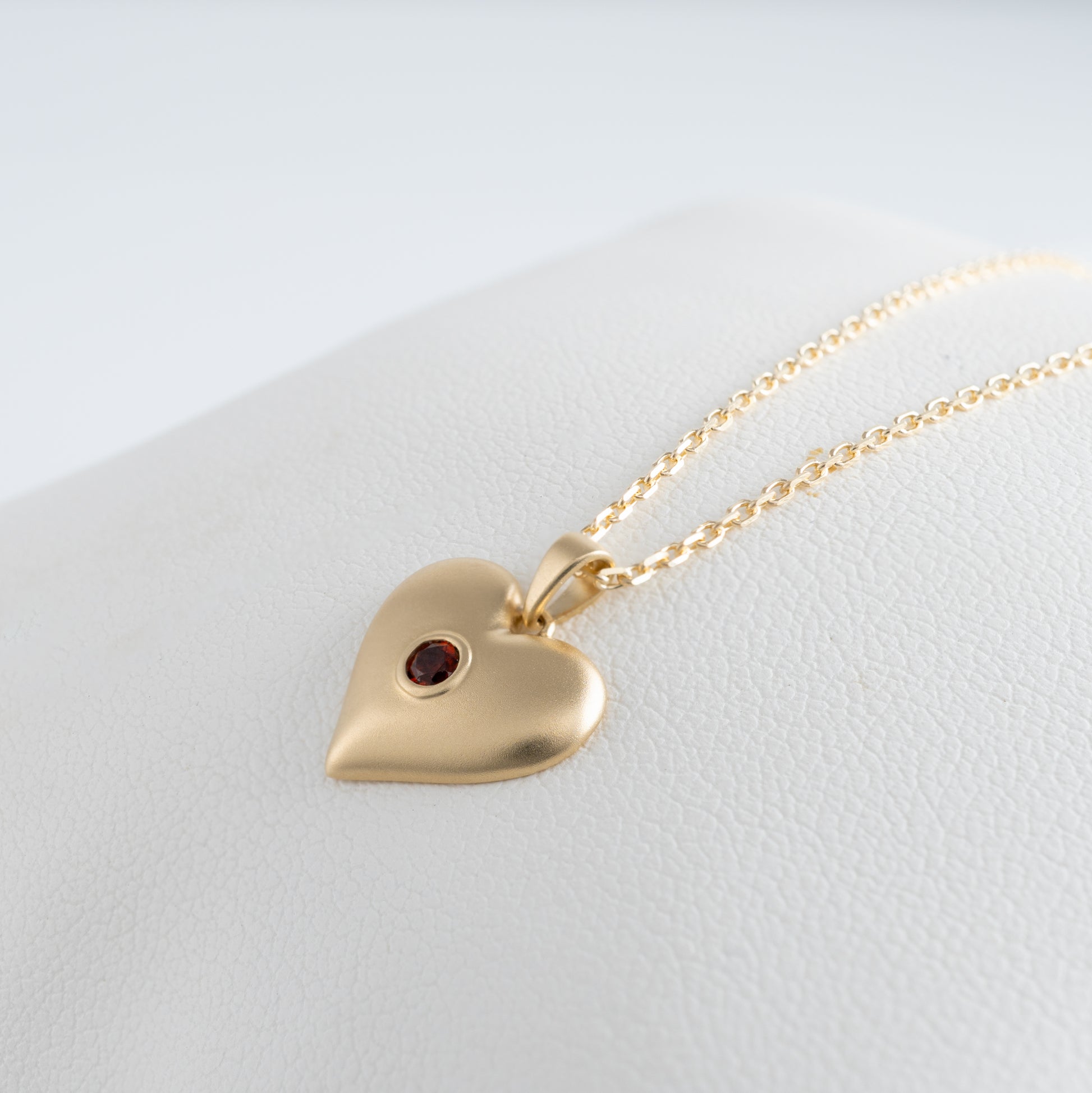 Side angle view of matte gold heart necklace pendant in 9ct gold