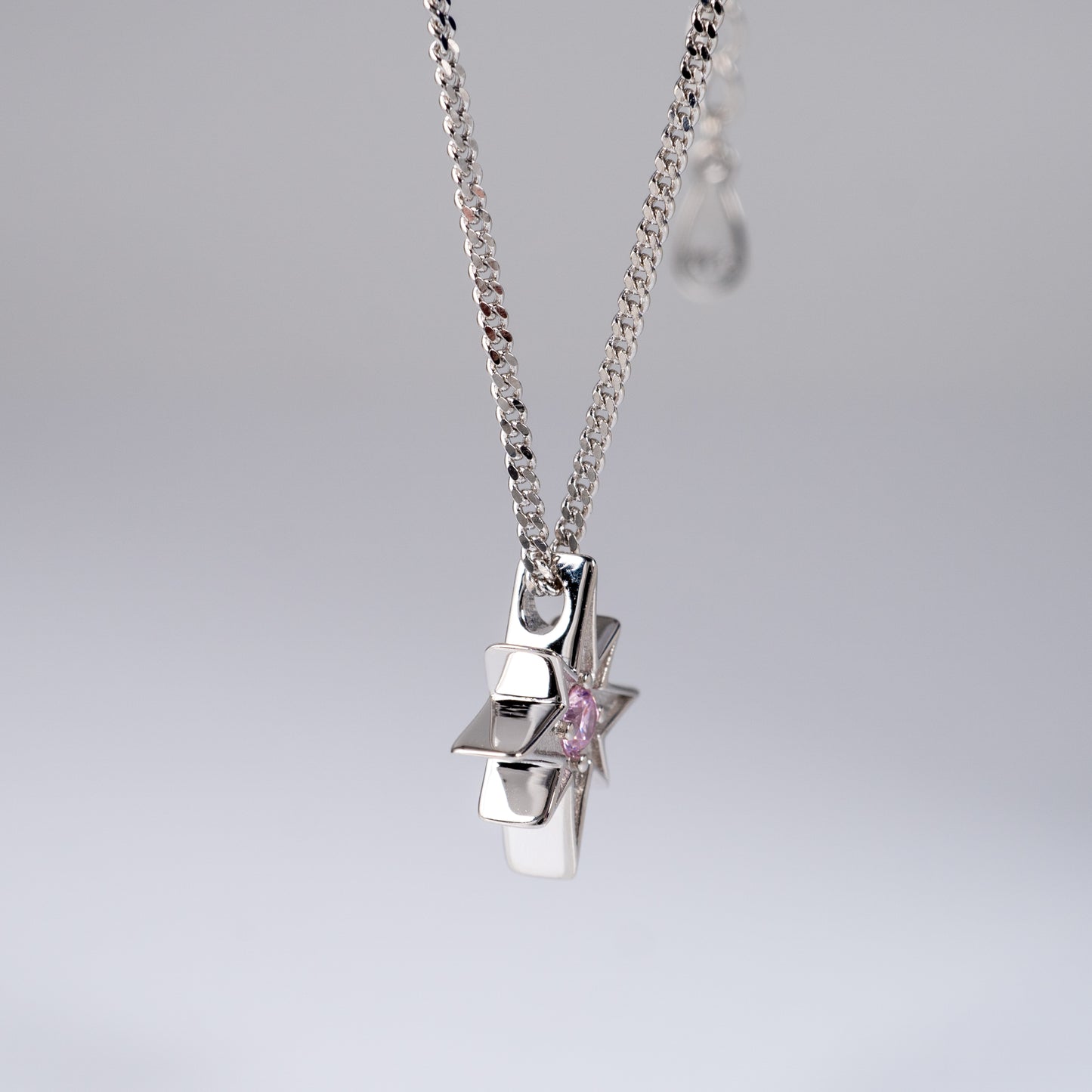 Side view of pink cubic zirconia North Star necklace in 925 silver
