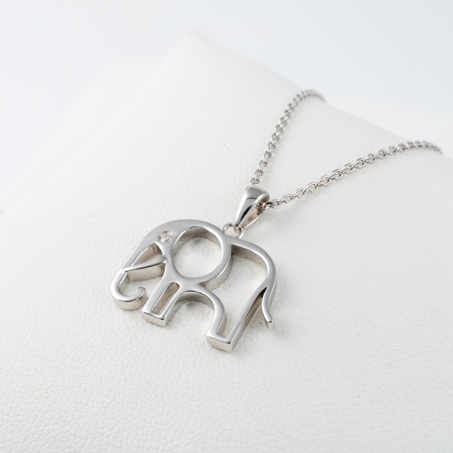 Silver elephant charm necklace on white leather – adjustable chain and polished finish