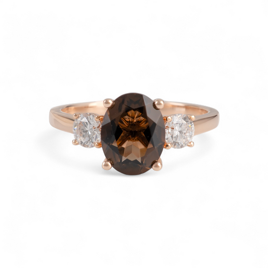 smoky quartz ring with a brown gemstone and two smaller diamonds on a white background