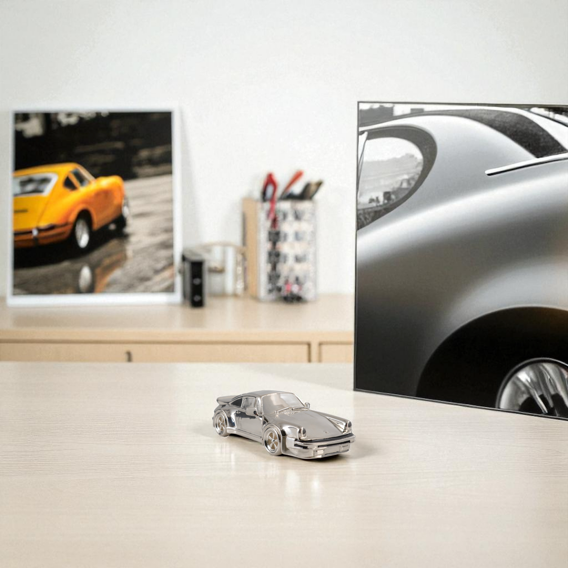 Sterling silver Porsche 911 miniature displayed on desk – elegant gift for Porsche fans and collectors