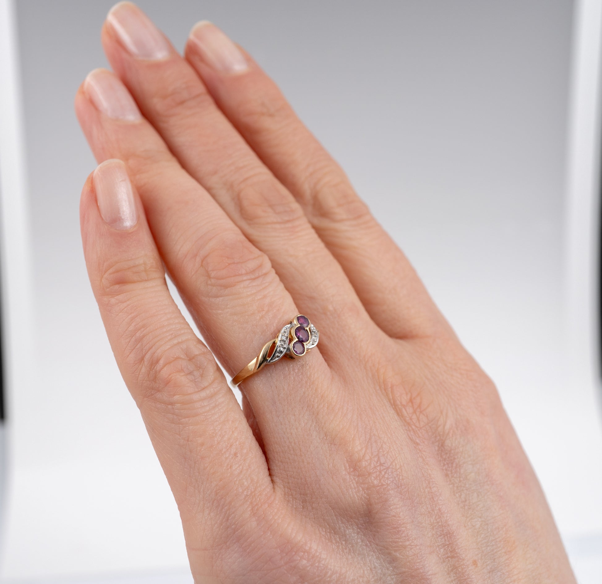Vintage Ruby Ring with Diamonds in 9ct Yellow Gold, displayed at a slight angle on hand