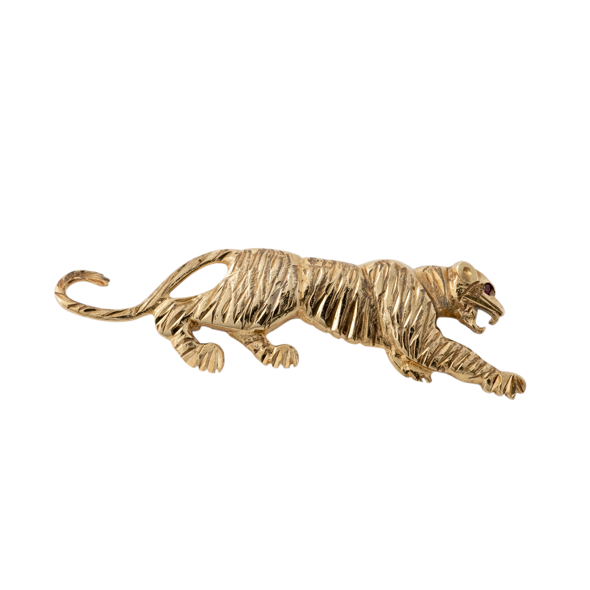 Vintage gold cat brooch featuring a prowling tiger design