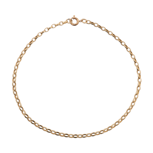 Women's belcher bracelet gold laid out on a white surface