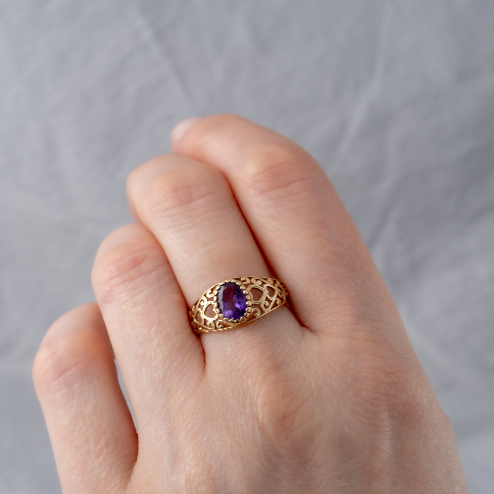 Amethyst ring on a woman's hand showing scale and fit, a perfect February birthstone gift