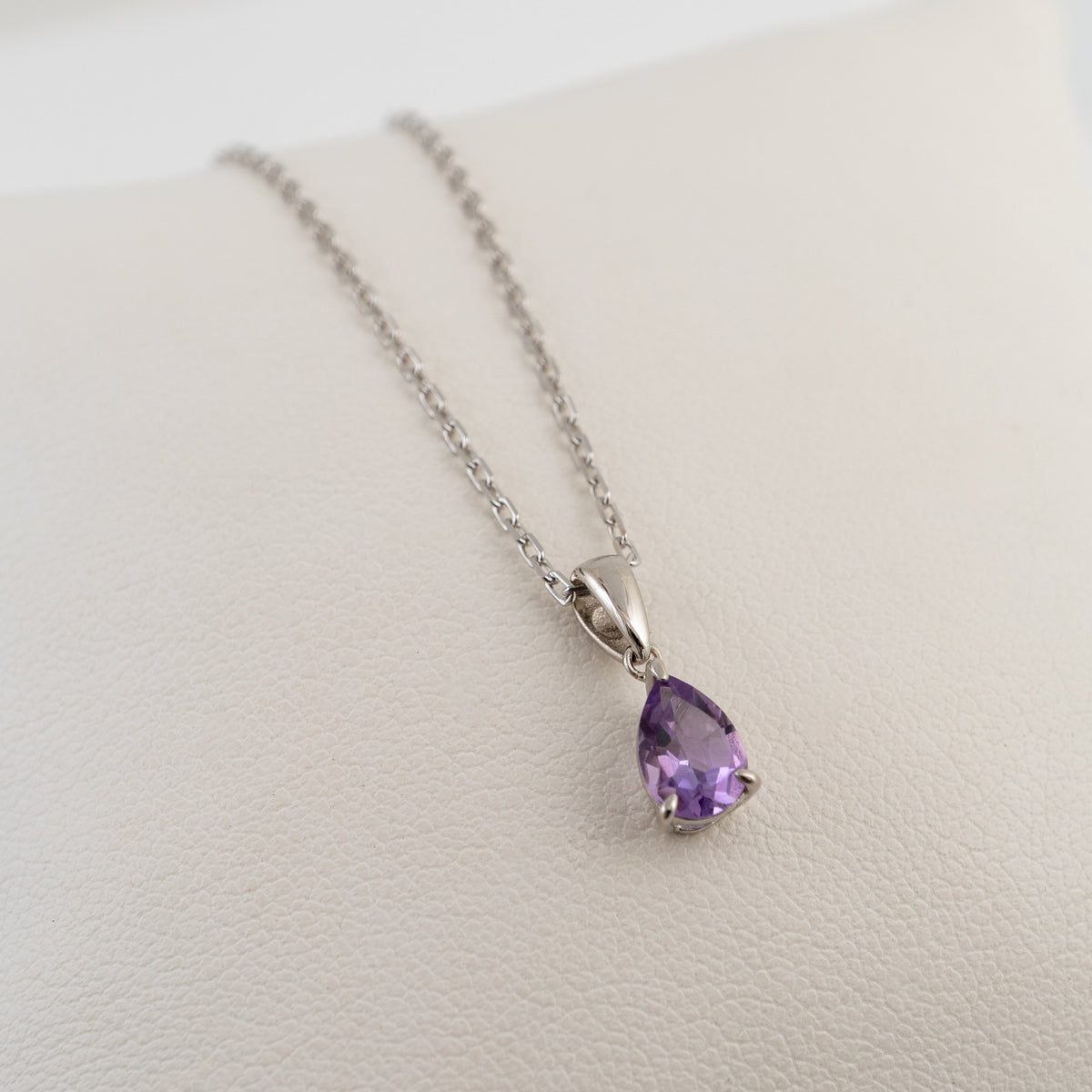 Sterling silver amethyst pear cut pendant shown at an angle